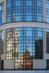 Reflection in the windows of the walls of the Kremlin and the building.
