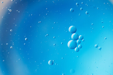 abstract light blue background with oil circles . bubbles of water close up .