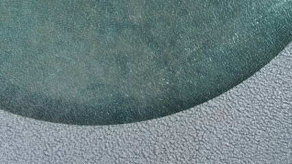 Cracked glass of a lantern in the alley of the park. Close-up.