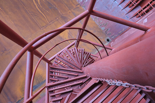 View from the top of spiral ladder inside cargo hold of cargo ship, bulk carrier