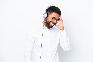 Telemarketer Brazilian man working with a headset isolated on white background laughing