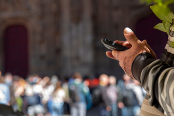older man's hands using a mobile phone