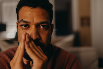 Fototapeta na wymiar Portrait od depressed young African - American man, looking at camera.