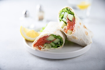 Healthy salmon wrap with fresh salad