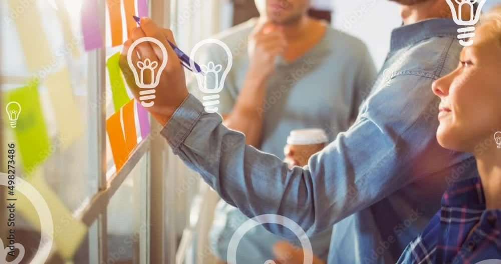 Poster animation of light bulb icons floating over business colleagues writing on memo notes