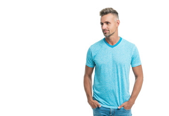 Fototapeta premium Happy handsome caucasian guy in casual style looking aside holding hands in pockets