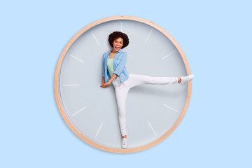 Photo image of funny lady stuck inside huge large clock use her legs instead of arrows have fun concept of time arrangement every second have cost