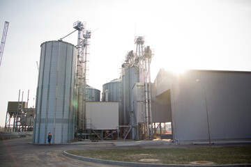 Construction of a feed mill agro-processing plant for processing and silos for drying cleaning and storage of agricultural products, flour, cereals and grain. The lights of a sun. © Евгений Гвоздев