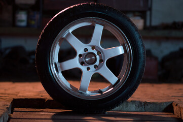 old white car rims in an old garage in the dark