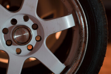 old white car rims in an old garage in the dark