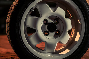 old white car rims in an old garage in the dark