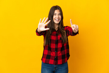 Teenager Brazilian girl isolated on yellow background counting six with fingers