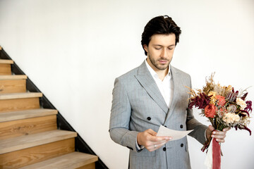 The groom reads the wedding vow to the bride with a bouquet in his hands