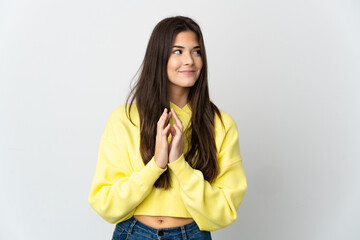 Teenager Brazilian girl isolated on white background scheming something