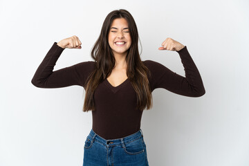 Teenager Brazilian girl isolated on white background doing strong gesture