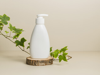 Mockup liquid soap dispenser or body lotion on wooden stand with leaves, pastel background, organic...