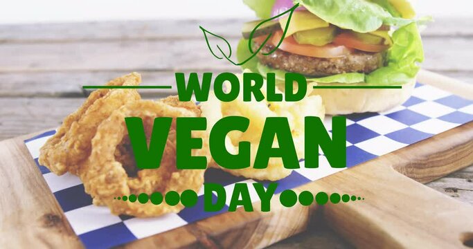 Animation of world vegan day text over fresh hamburger