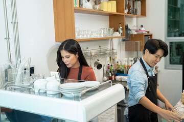 Barista using a coffee maker to coffee,Cafe worker making a coffee,Cafe owner in apron making coffee.