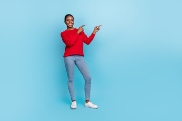 Full size photo of sweet young brunette lady index promo wear shirt jeans sneakers isolated on blue background