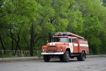 An old fire truck driving on the road