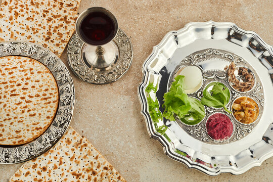 Passover Seder plate with traditional food ontravertine stone background