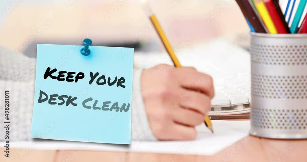 Poster animation of keep your desk clean text over hand of caucasian student writing in notebook