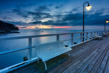 Beautiful landscape with wooden pier in Gdynia Orlowo at sunrise, Poland