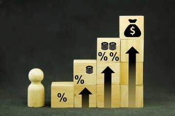 wooden cubes arranged on a ladder with percentage and money icons. the concept of increased profits