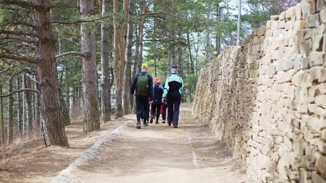 tourists walks along the path of the terrain course in the mountain park