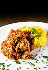 Fried liver with onion and mashed potatoes on white plate