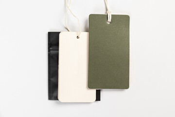 a pair of fashionable blank labels for clothes on a gray background
