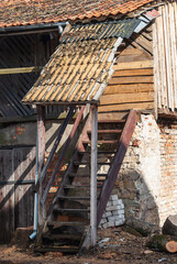 Old wooden stairs near the house in sunny spring day, Kuldiga, Latvia.