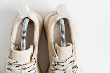 part of modern sneakers made of combined materials and colors with Flexible plastic spring mold holders for shoe storage. fashion shoe boutique. online store. 