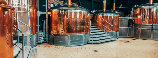 Brewery equipment. Brew manufacturing. Round cooper storage tanks for beer fermentation and...