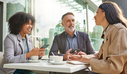 When did you realise this. Shot of a group of colleagues brainstorming ideas at a coffee shop while...
