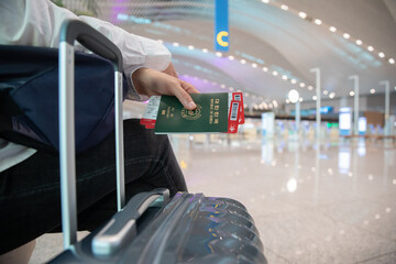 A woman sitting and waiting after completing ticketing at the airport