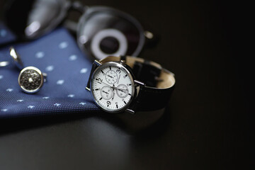 Obraz na płótnie Canvas Business accessories. Luxury men's watch with cufflinks, breastplate and sunglasses close up.