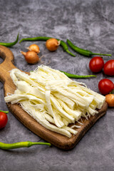 Cecil cheese or String cheese on a dark floor. Delicious assortment of cheeses. close up