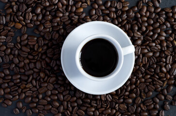 Top View of White Coffee Cup Surrounded with Coffee Beans