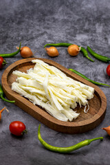 Cecil cheese or String cheese on a dark floor. Delicious assortment of cheeses. close up