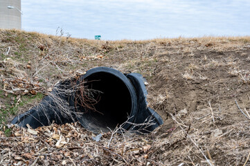 HDPE drainage culvert under a road entrance. Pipe is used to convey stormwater between ditches. - obrazy, fototapety, plakaty