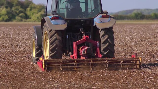 Close up of a powered harrow in action. Slow motion
