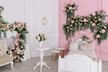 A children's room decorated with flowers, a baby bed, a fireplace decorated with flowers