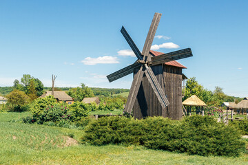 Fototapeta na wymiar Ancient wooden windmill in the village of Pustovoitovka, Sumy region, Ukraine