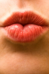 macro of a young girl lips kissing