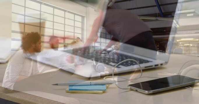 Animation of laptop over group of business people in office