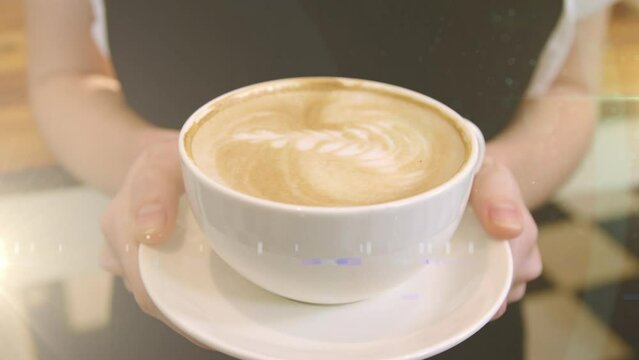 Animation of light spots over hands of caucasian woman holding cup of coffee