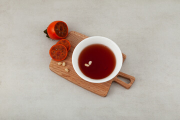 Sujeonggwa - Korean cold fruit tea or chilled punch. It is made from persimmons and cinnamon,...