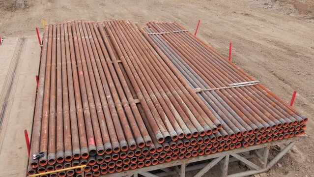 The top drive system of a drilling rig. The oil pipes are in a row