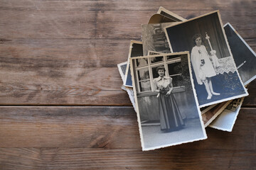 old family photographs, pictures from 1935 in sepia color on wooden table, home archive documents,...